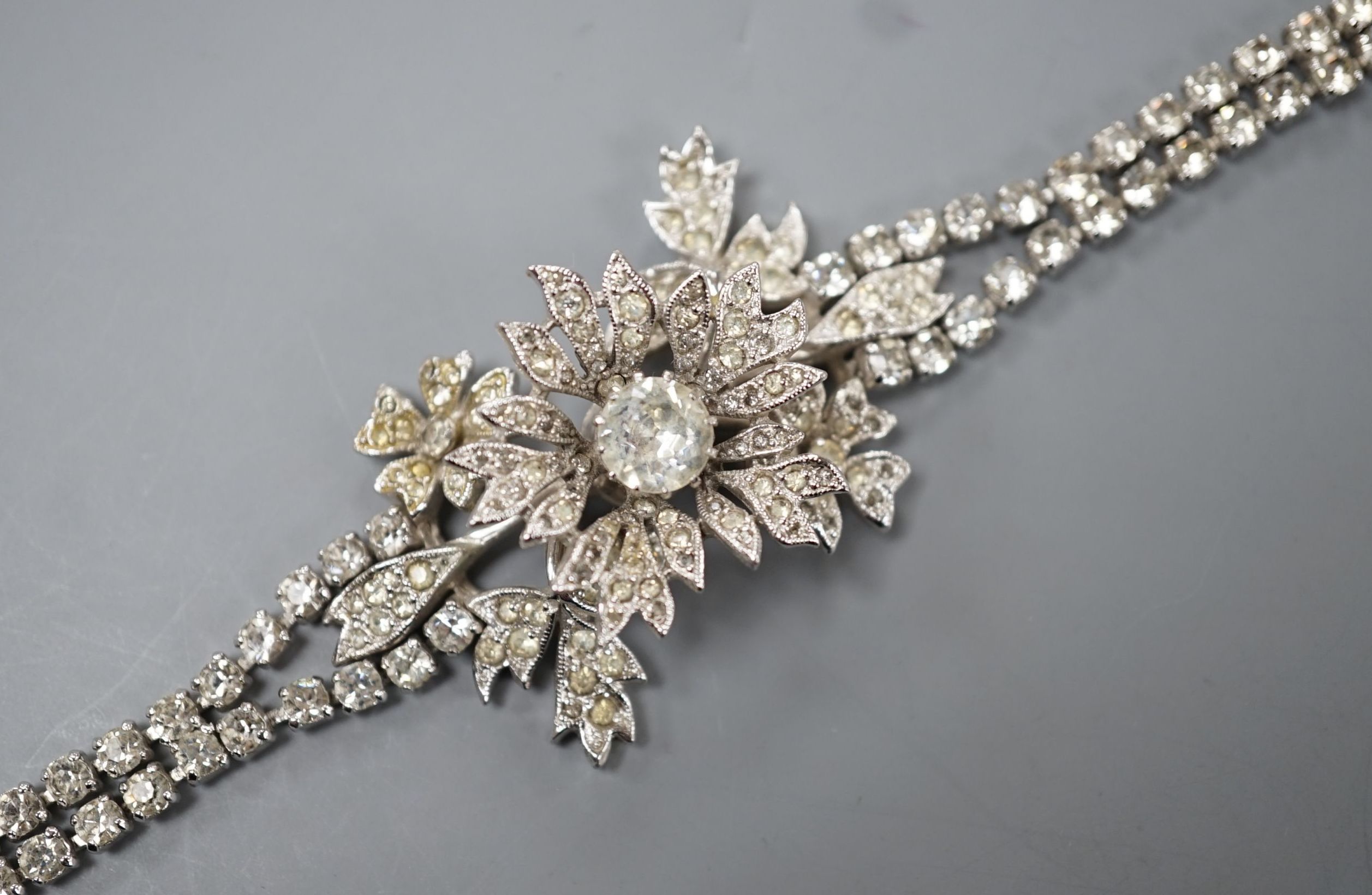A Christian Dior paste cluster set bracelet, with central en tremblent floral motif, 19cm.